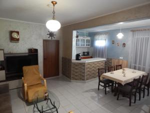 a kitchen and dining room with a table and chairs at Kristi Houses in Krapets