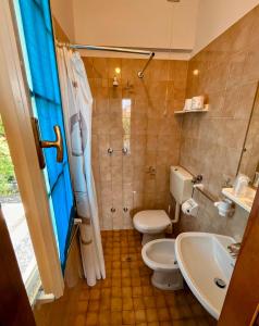 a bathroom with a toilet and a sink and a shower at Dipendenza BeB Villa Denny in Rimini +17 photos