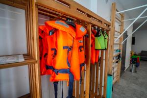 a rack with orange and green gear in a room at Ant House Complex - Luksusowe domy SPA in Ryn