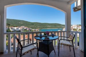 a balcony with a table and chairs and a view at Villa Piccolotti in Neum