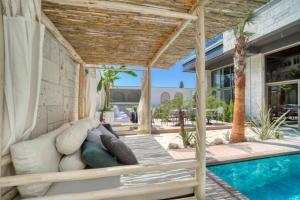 a patio with a couch and a swimming pool at Ayayorgi Homes in Çeşme