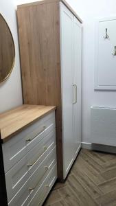 a closet with a white dresser and a mirror at APARTAMENT JARACZA 28 Nr 3 in Słupsk +13 photos