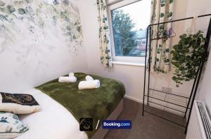 a room with a bed with two pillows on it at Modern 4-Bed House, Free Parking & WiFi in Swinton in Manchester