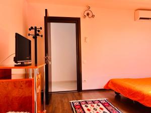 a bedroom with a cross on the wall next to a door at Vila Rin in Mangalia