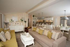 a living room with a couch and a kitchen at The Shore in Eyemouth