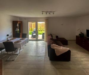 a person laying on a couch in a living room at Lusowo DOM in Lusowo