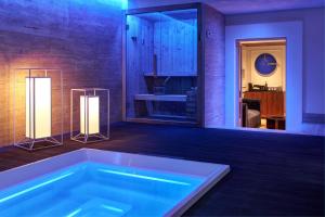 a bath tub in a room with two lights at The First Arte - Preferred Hotels & Resorts in Rome