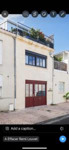 an image of a house with a red garage at Échoppe contemporaine - Bordeauxlidays in Bordeaux