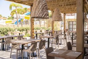 a row of tables and chairs in a restaurant at Costa Lindia Blue Star - Adults Only in Lartos