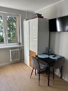 a kitchen with a table and chairs in a room at A&P Studio in Gdynia