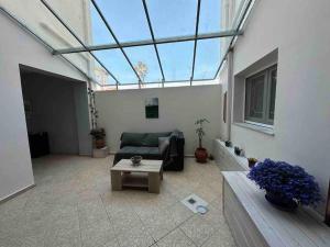 a living room with a couch and a glass ceiling at Effies Apartments in Karlovasi
