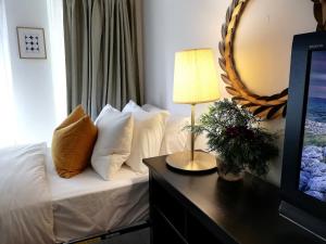 a bedroom with a bed with white pillows and a mirror at Stylish Downtown Toronto Residential Hotel in Toronto +38 photos