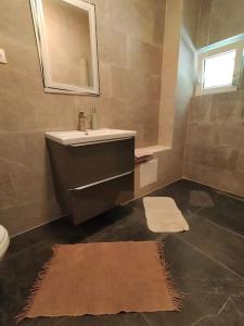 a bathroom with a sink and a mirror at Tarnita Summer House in Someşu Cald +10 photos