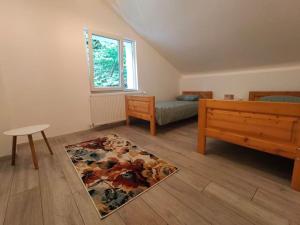 a bedroom with a bed and a rug on the floor at Tarnita Summer House in Someşu Cald