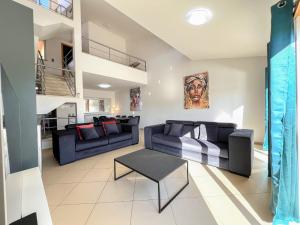 a living room with two couches and a table at Fantastic Villa, Private Pool, BBQ, AC and Wi-Fi in Quarteira