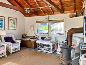 a living room with white chairs and a table and a fireplace at Elegant Nantucket Retreat on Village Way 3BR in Nantucket