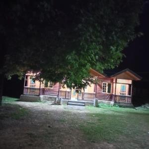 a house at night with a bench in front of it at Grand View Resorts Chatpal in Anantnāg