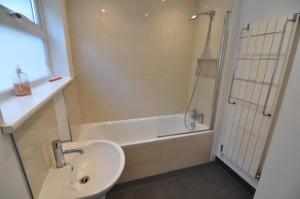 a bathroom with a sink and a tub and a shower at Exeter Quay & City Centre St Leonards in Exeter +8 photos