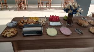 a table topped with lots of different types of cheeses at PARALELO 9s HOTEL in Petrolina