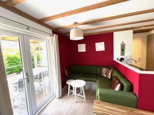 a living room with a green couch and a table at Bospark Wolfsven - BPW 1583 in Mierlo
