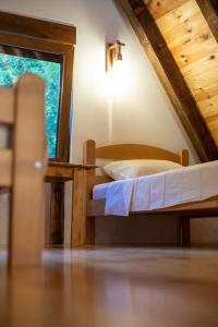 a bedroom with a bed and a window in a attic at Boricje Village Escape in Plužine