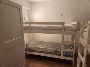a small room with two bunk beds in it at Majestic in De Panne