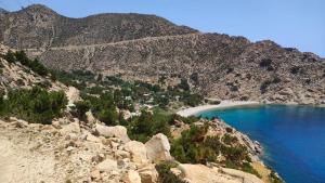 a view of a mountain with blue water and a beach at SPITIKARIOTIKO My Ikarian home in Raches