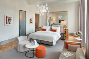 a hotel room with a bed and a couch at Hotel BOOKQUET in Prague