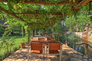 a wooden table and chairs under a pergola at Dalya Life in Göcek