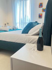a bedroom with two beds and a bottle on a table at Il Nido Guest House in Piacenza +28 photos