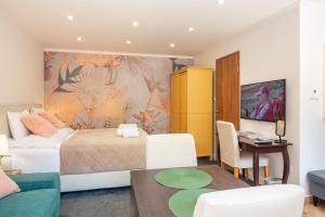 a bedroom with a bed and a dining room at Monbuhim Comfort in Veszprém