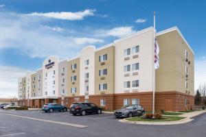 a hotel with cars parked in a parking lot at Candlewood Suites Paducah by IHG in Paducah