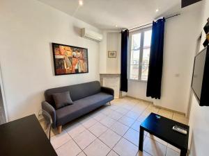 a living room with a couch and a table at Viva Riviera Residence Rue Florian close Croisette in Cannes