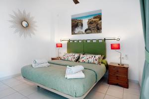 a bedroom with a bed with two towels on it at Los Molinos 4306 in Costa Teguise