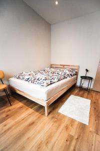 a bedroom with a bed and a wooden floor at Ferienwohnung in Lengefeld in Lengefeld +7 photos