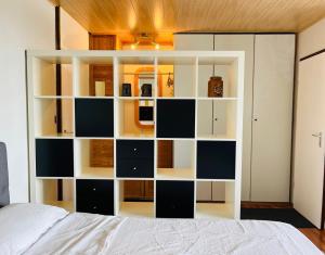 a bedroom with a large white and black book shelf at Panoramic View Harz in Altenau