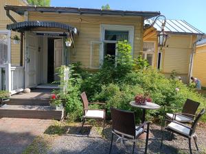 un patio con sillas y una mesa frente a una casa en Villa GABi, en Naantali