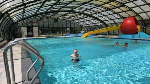 a group of people swimming in a swimming pool at Chalet205, vanaf 2027 Chalet207A in Laag-Soeren