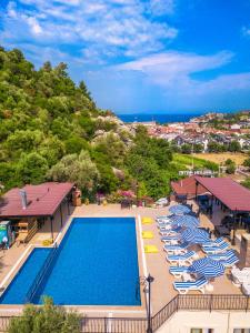 an overhead view of a swimming pool with chairs and umbrellas at LESLION HOTEL TURUNC in Marmaris
