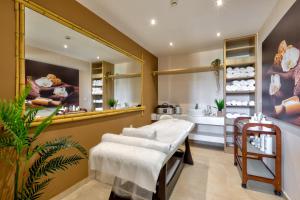 a room with a kitchen with a table and sinks at White Olive Premium Laganas in Laganas