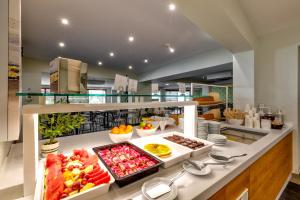 a buffet with many different types of food on a counter at White Olive Premium Laganas in Laganas
