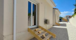 a bench next to a building with a window at Les Pins du Lac II in Lacoste