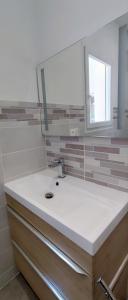 a bathroom with a sink and a mirror at Les Pins du Lac II in Lacoste