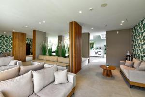 a living room with two couches and a table at White Olive Premium Laganas in Laganas