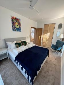 a bedroom with a large bed with a blue blanket at Leo House in Gdynia