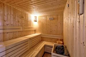 a wooden sauna with a bench in the middle at White Olive Premium Laganas in Laganas