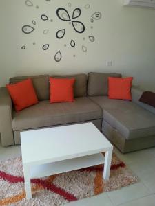 a living room with a couch and a coffee table at Potamos Apartment in Limassol