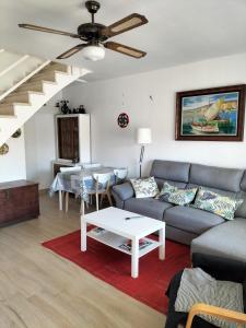 a living room with a couch and a table at CASA DE MARINEROS en LA RIA DEL ROMPIDO in Cartaya