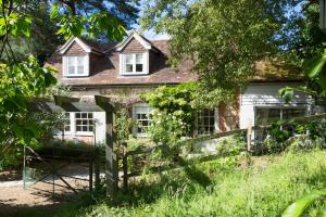 an old house with a fence in front of it at Coach House Kent in Seal