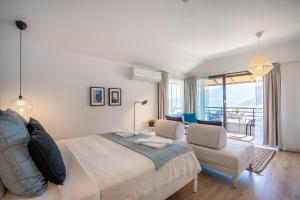 a bedroom with a large bed and a living room at True Blue Boutique Hotel Kalkan in Kalkan +71 photos